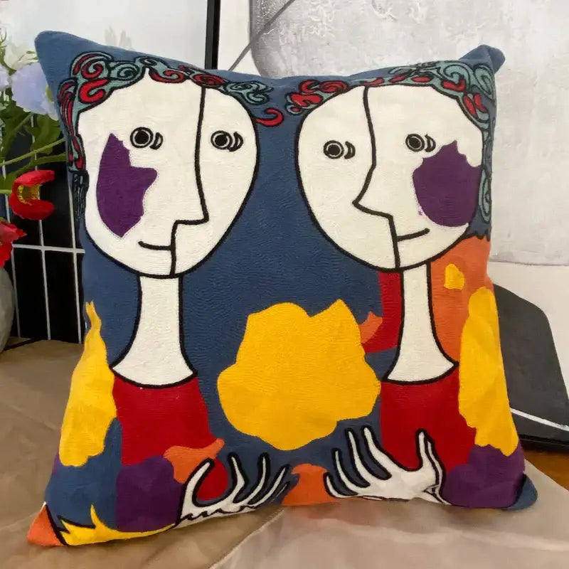 Square cushion with decorbites abstract embroidery pillowcase featuring stylized faces on deep blue background