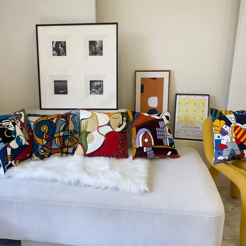 A white sofa decorated with decorbites abstract embroidery colorful geometric and figurative throw pillows 45x45cm