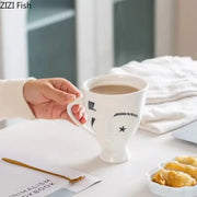 White ceramic mug with black decorbites abstract face ceramic star design for coffee tea and juice use