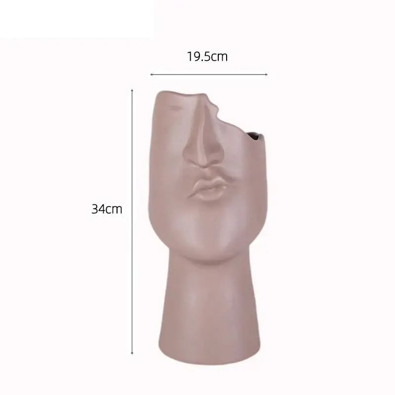 Matte blush pink decorbites abstract face ceramic vase with stylized human features and open top for table decoration