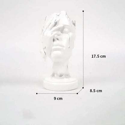 A glossy white ceramic bust sculpture featuring a decorbites abstract face mask design for home decor use
