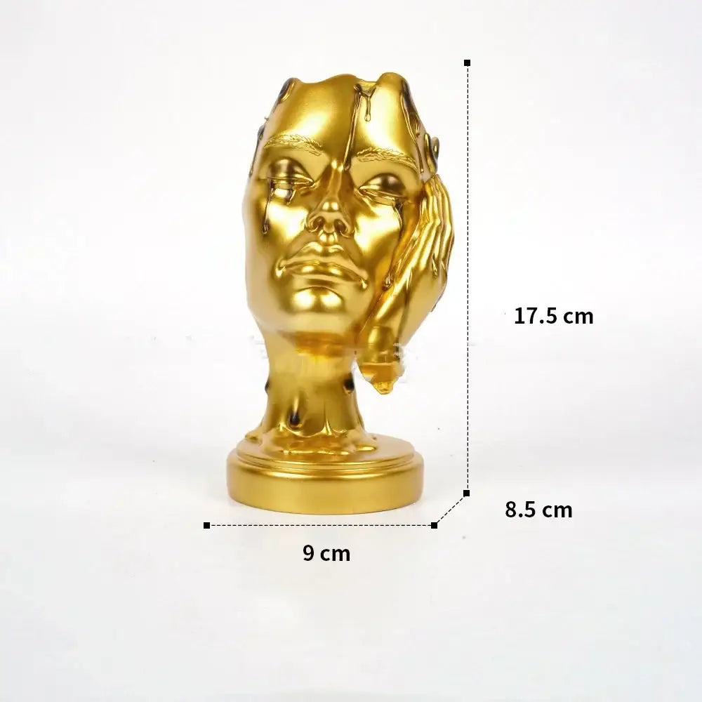 Golden metallic DecorBites™ abstract face mask resin statue with melting effect for elegant home decor use