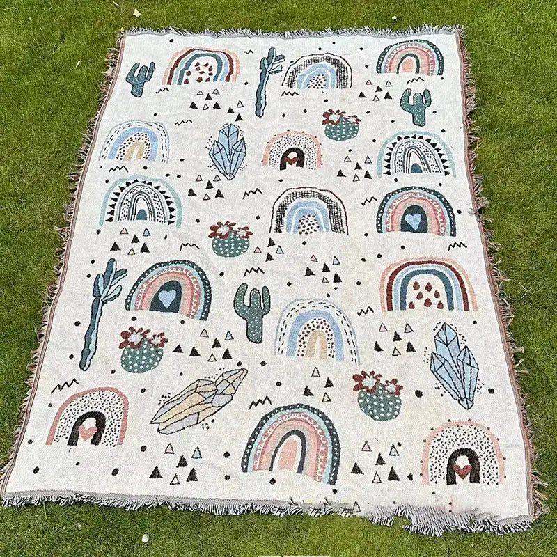 Decorbites abstract face pattern throw blanket in off-white woven fabric with colorful rainbows cacti and crystals