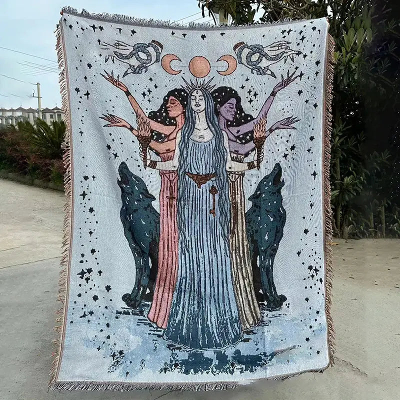 A decorbites abstract face pattern throw featuring a mystical tapestry design of three women with wolves and celestial symbols