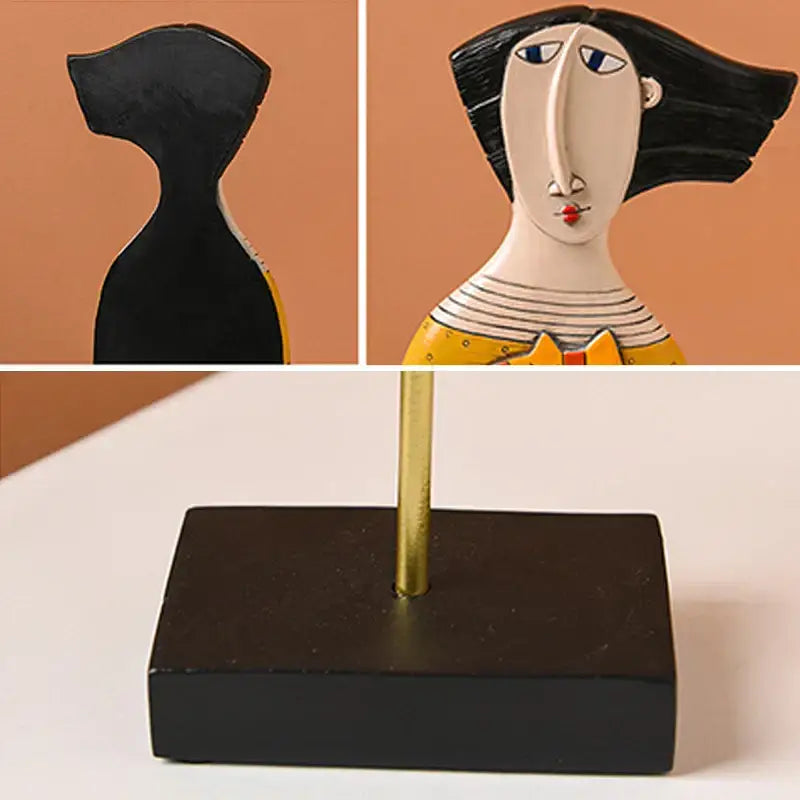 Stylized ceramic figurine of a woman with black hair and yellow dress in decorbites abstract face resin art ornament statue