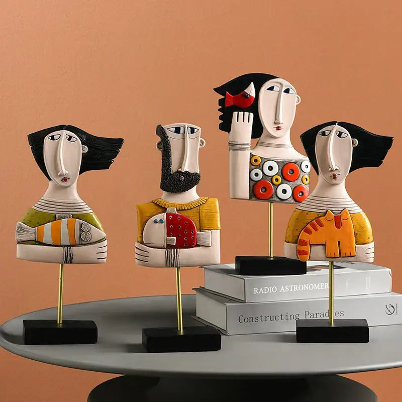 Stylized decorbites abstract face resin art ornament figures with bold black hair colorful patterns and gold stands