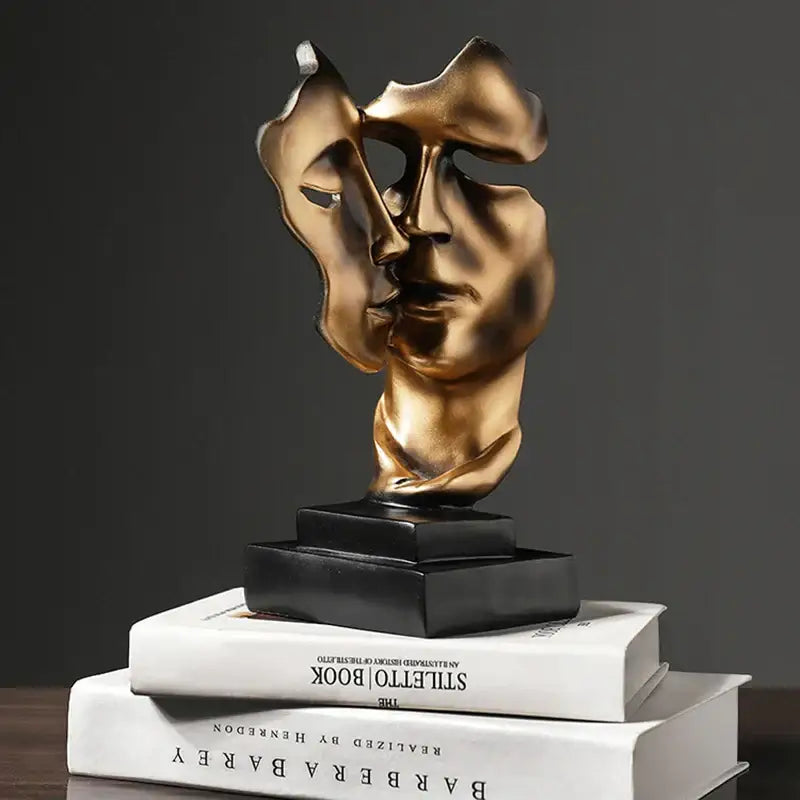 Bronze-colored DecorBites™ abstract face sculpture ornament with split design on black base for home decor and wedding gift