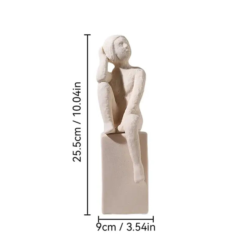 Minimalist white ceramic DecorBites abstract family character sculpture seated with hand on head on rectangular base