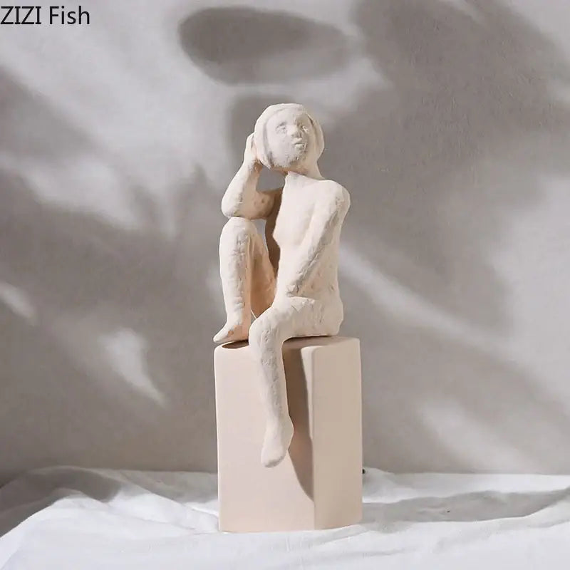 Cream-colored ceramic decorbites abstract family character sculpture of seated person with hand resting on head desk decor