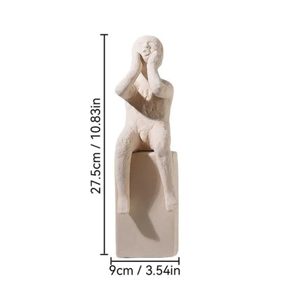 Cream-colored decorbites abstract family resin sculpture of seated figure with hands covering face on matching base