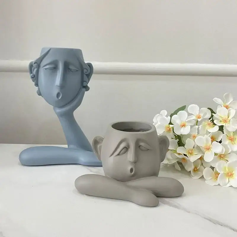 Two sculptural face-shaped flowerpot ornaments in muted blue and gray by DecorBites abstract family for home decor