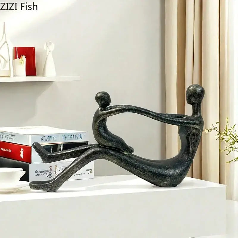 Black matte finished DecorBites™ abstract family resin sculpture depicting two figures in an intimate embrace for decor