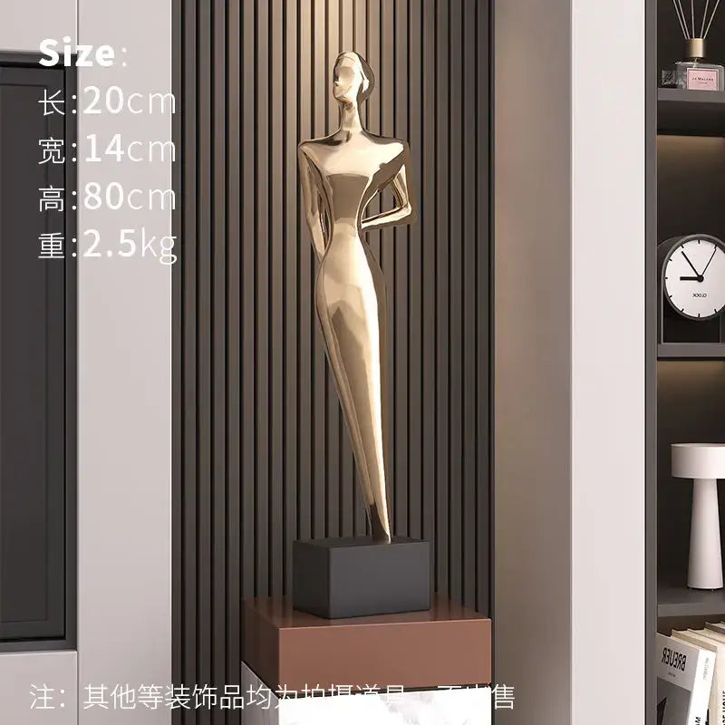 Golden metallic decorbites abstract figure art sculpture of a stylized woman in an elegant gown for luxury living room decor