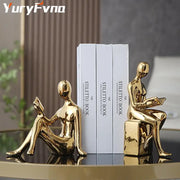 Decorbites abstract figure bookend set featuring golden glossy seated human figures reading books for stylish decor