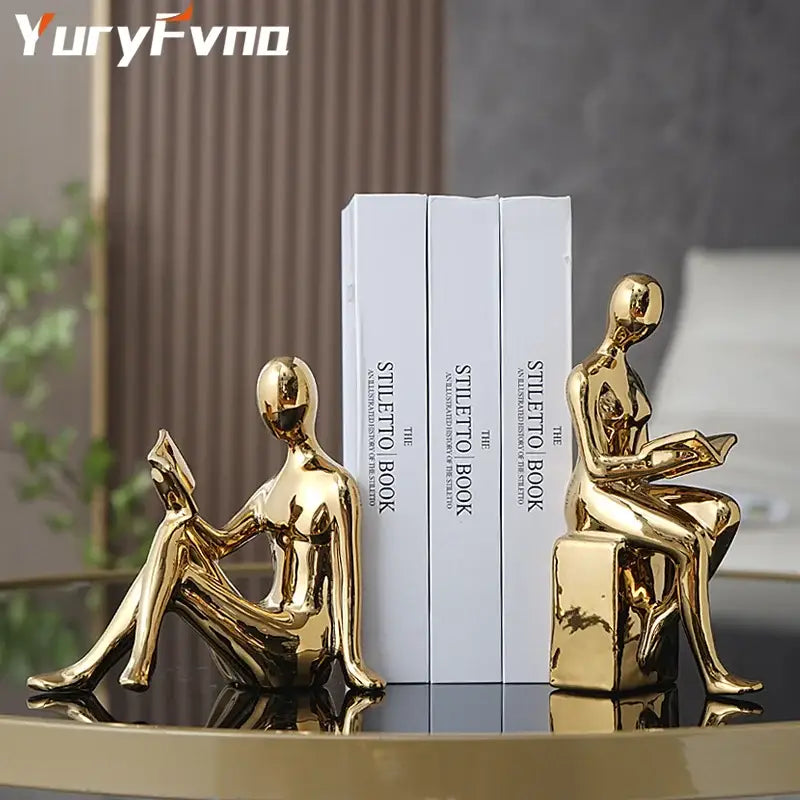 Decorbites abstract figure bookend set featuring golden glossy seated human figures reading books for stylish decor
