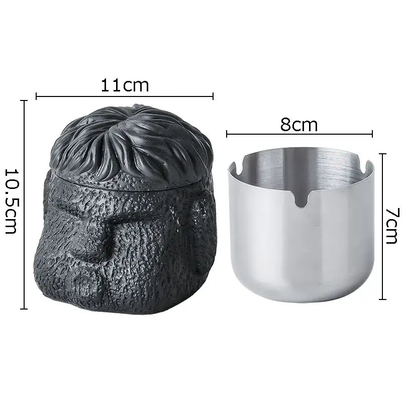 Black textured skull-shaped portraits cement ashtray with matching lid and silver metallic base for smoking accessories