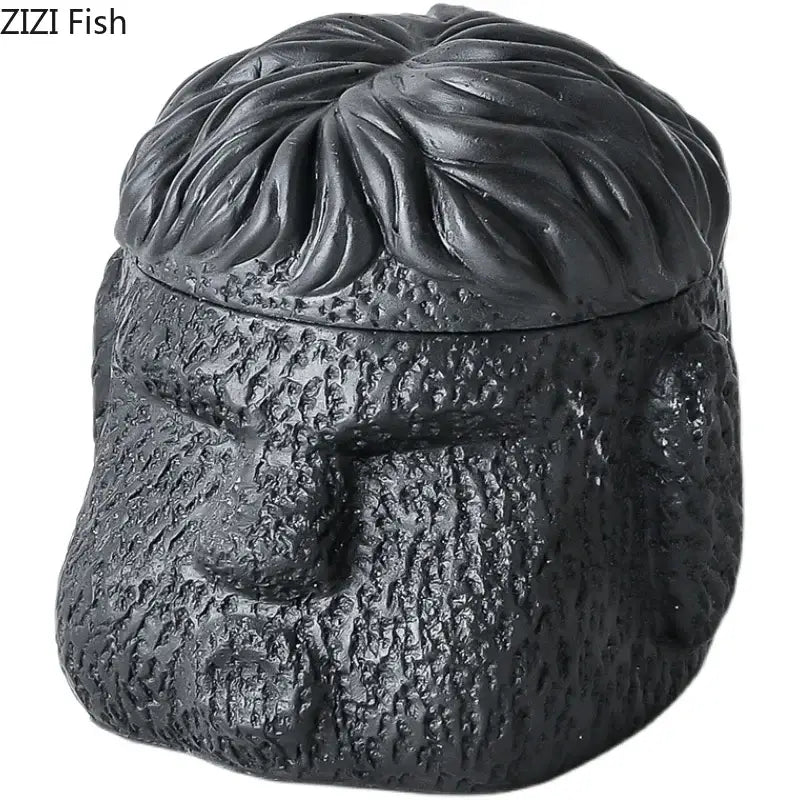 Black ceramic jar shaped like a man’s head with textured features used as portraits cement ashtray by DecorBites™