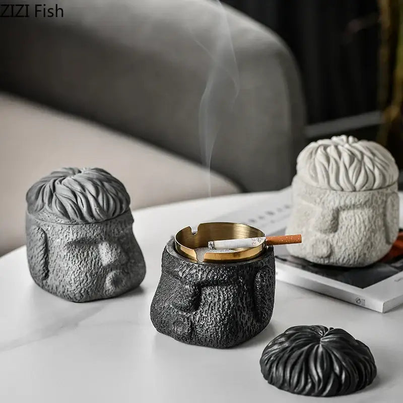 Black textured figure portraits cement ashtray shaped like a human head with gold-colored inner tray and lid for smoking accessories
