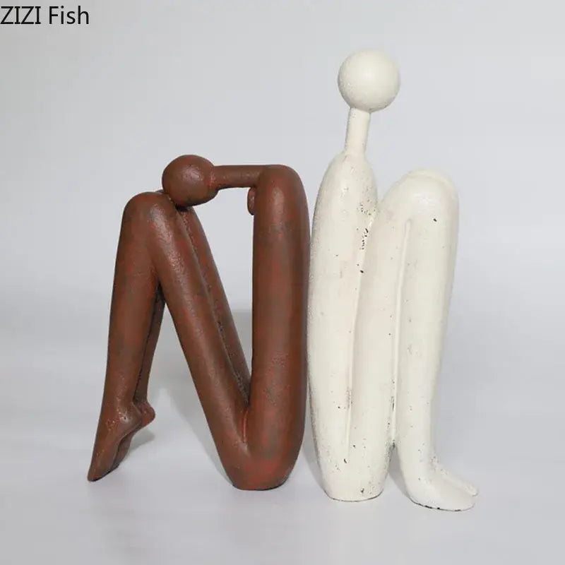 Two matte brown and off-white speckled resin sculptures of decorbites abstract figure desk decor for modern home