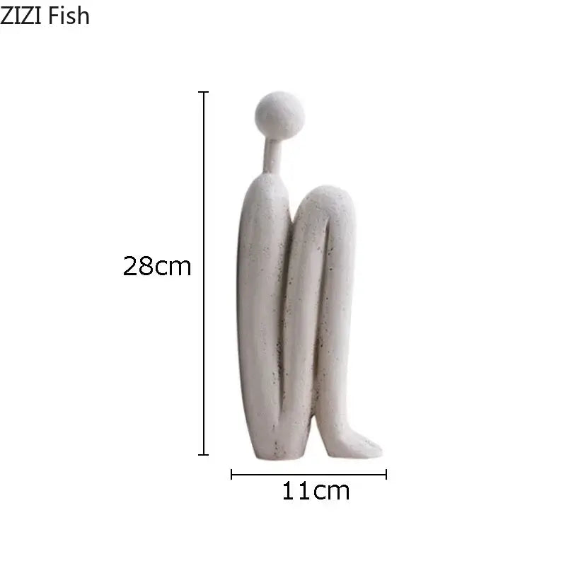 Minimalist white ceramic resin sculpture decorbites abstract figure depicting a smooth seated abstract figure for desk decor