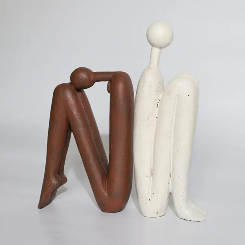 Two decorbites abstract figure resin sculptures in earthy brown and matte white for modern desk decor