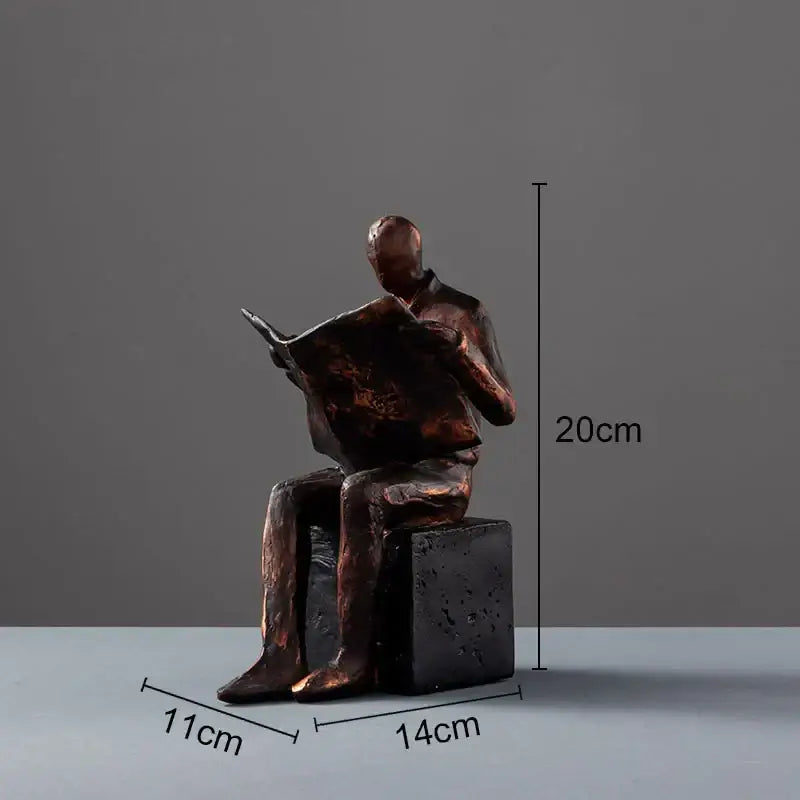 Bronze-colored decorbites abstract figure sculpture of a seated man reading newspaper resin figure sculpture bookend with dark base