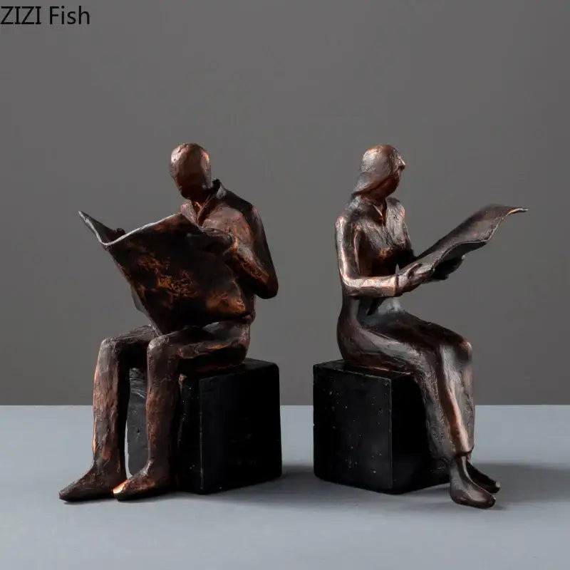 Bronze decorbites abstract figure sculpture bookend of man and woman reading newspapers on black resin cube bases