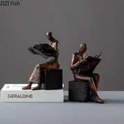 Decorbites abstract figure bronze resin sculpture bookend featuring two seated individuals reading on black cube bases