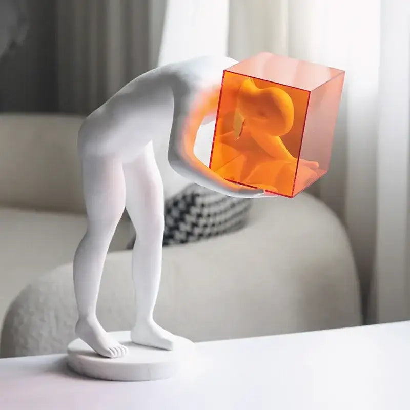 DecorBites™ abstract figure sculpture with glossy white cage human body and translucent orange cube head decor figurine