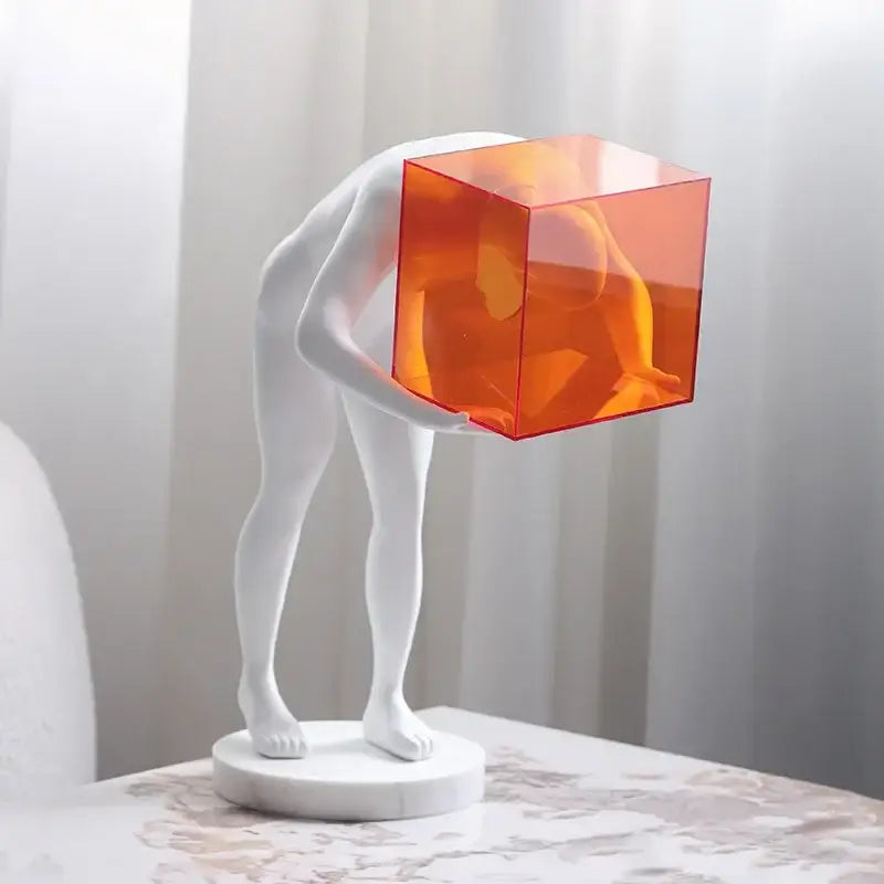 Decorbites™ abstract sculpture of a white human body mind figure with a translucent orange cage head on a marble base