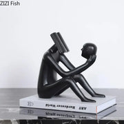 Black glossy resin decorbites abstract figure sculpture of seated figure with book head and book to face for room decor
