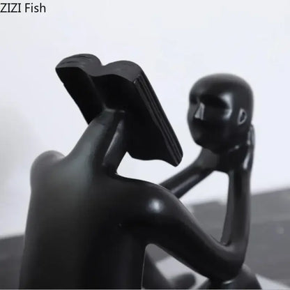 Black glossy resin decorbites abstract figure sculpture of a person reading a book for room aesthetic appeal