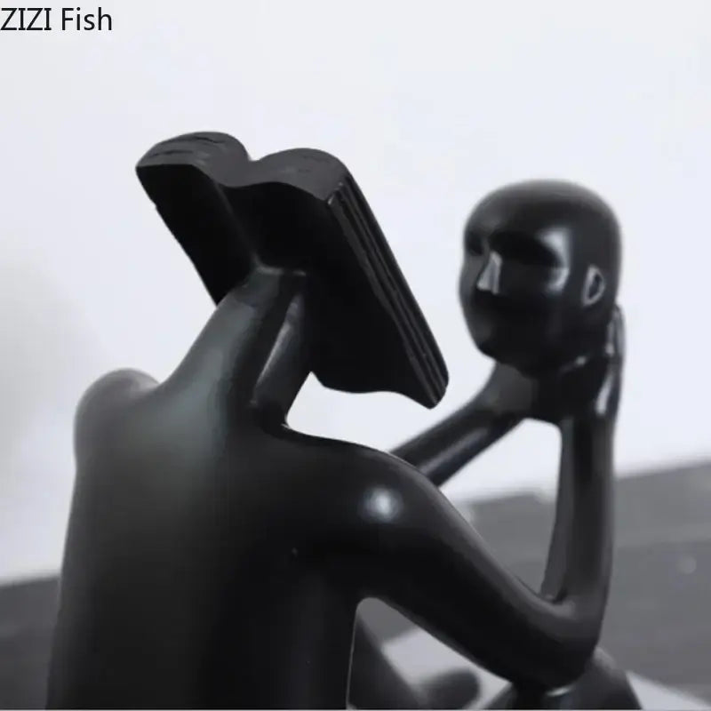 Black glossy resin decorbites abstract figure sculpture of a person reading a book for room aesthetic appeal