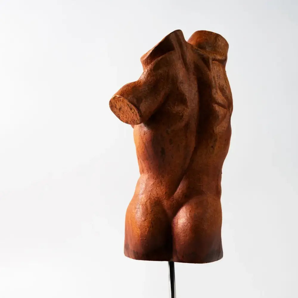 Rust-colored textured metal decorbites abstract figure sculpture decorative figurine of a male torso by david brokeback