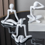 Three minimalist white ceramic decorbites abstract figures ornament sculpture depicting abstract human poses for home decor