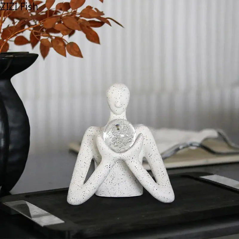 White speckled ceramic decorbites abstract figures sculpture decor cradling clear textured glass orb for room aesthetics