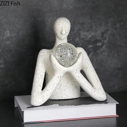 White speckled ceramic decorbites abstract figures sculpture holding clear glass orb with embedded crystals for sculpture decor