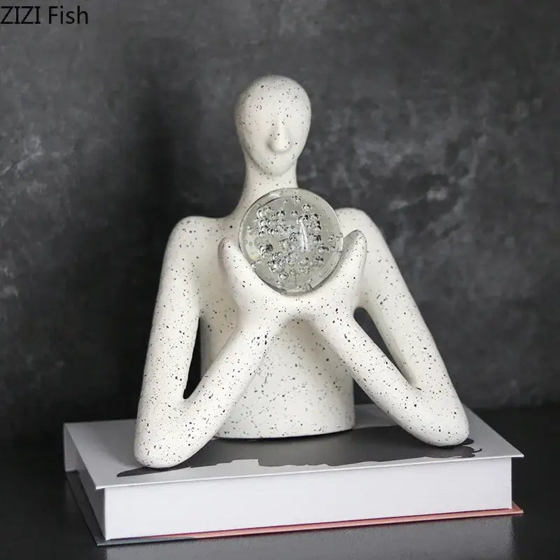 White speckled ceramic decorbites abstract figures sculpture holding clear glass orb with embedded crystals for sculpture decor
