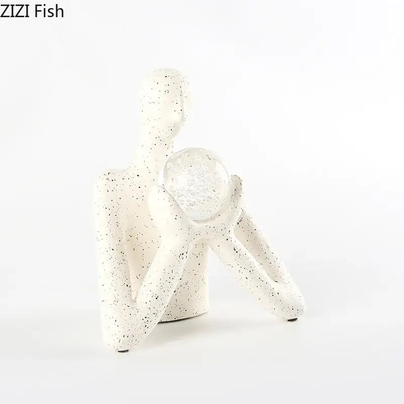White speckled resin decorbites abstract figures sculpture holding a clear glass sphere for sculpture decor
