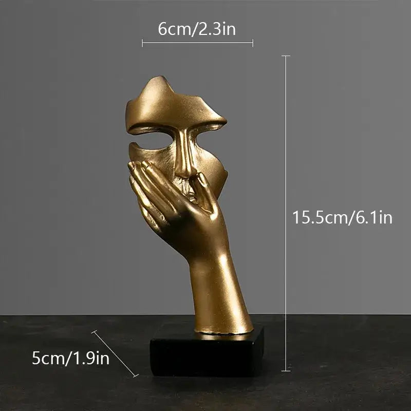 Golden metallic abstract figurines face sculpture with hand covering mouth on black base decorbites abstract figurines