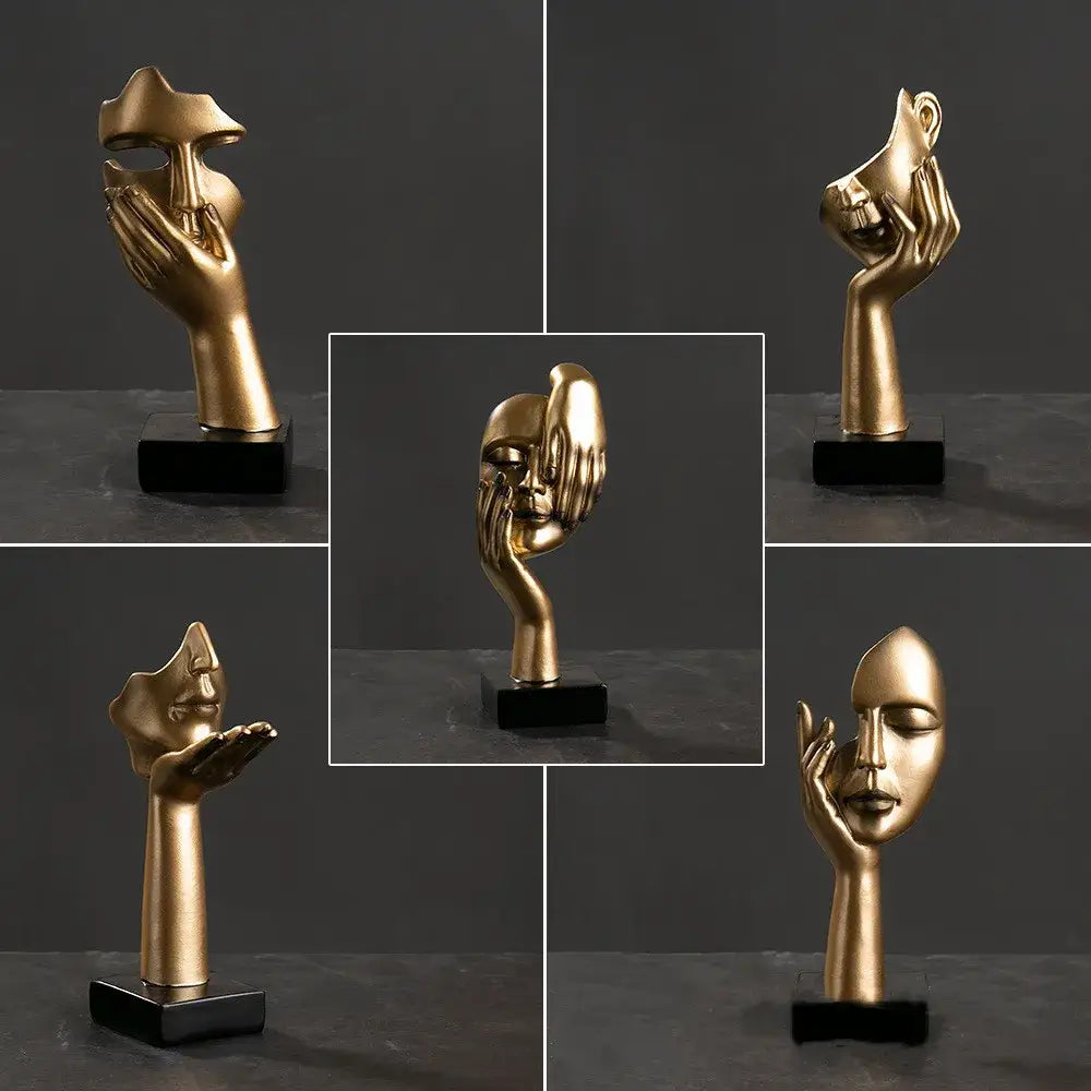 Golden metallic decorbites abstract figurines sculpture of a hand cradling a stylized face on a black base for home decor