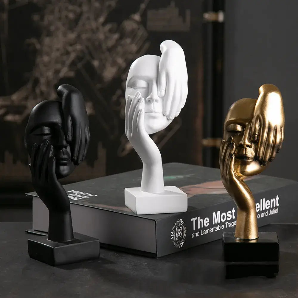 Three minimalist decorbites abstract figurines in black white and gold with hands covering eyes for modern home decor