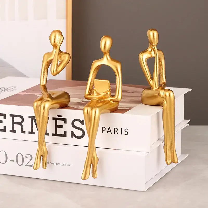 Three golden minimalist decorbites abstract figurines set featuring smooth glossy surfaces for modern home decor