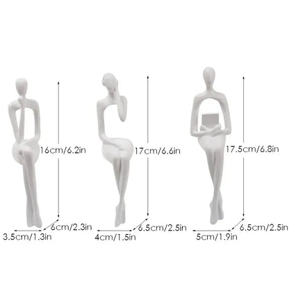 Three minimalist white resin decorbites abstract figurines set depicting stylized seated women for home and office decor