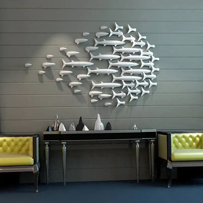 White metallic decorbites abstract fish ceramic wall sculpture arranged in swirling school pattern for children’s room