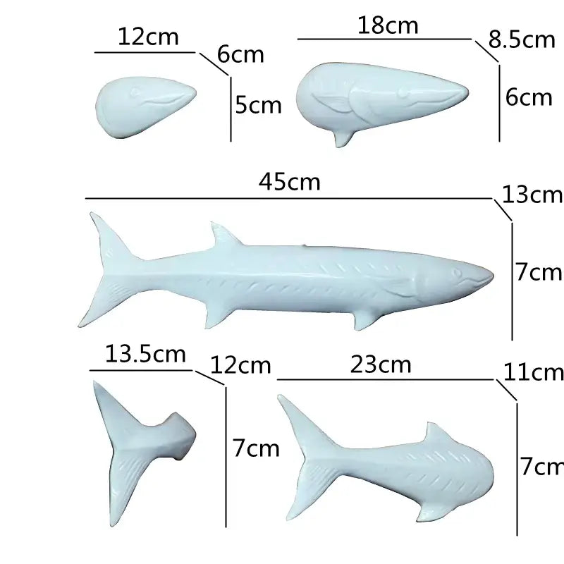 Set of four light blue abstract fish ceramic figurines in various sizes from decorbites abstract fish wall decoration set