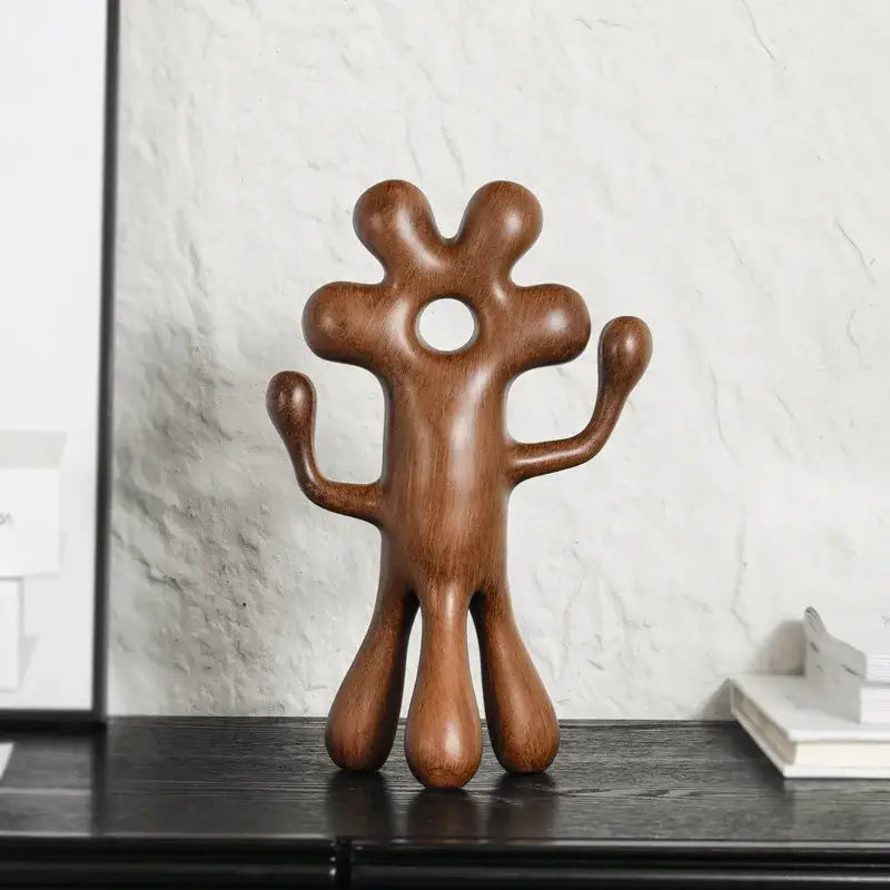 A smooth polished wooden decorbites abstract flower man sculpture with rounded limbs for home decor