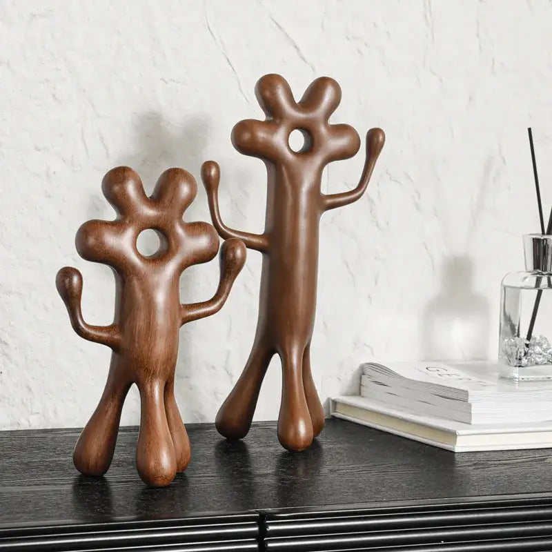 Two abstract wooden figurines with smooth rounded forms and circular cutouts from decorbites abstract flower home decor