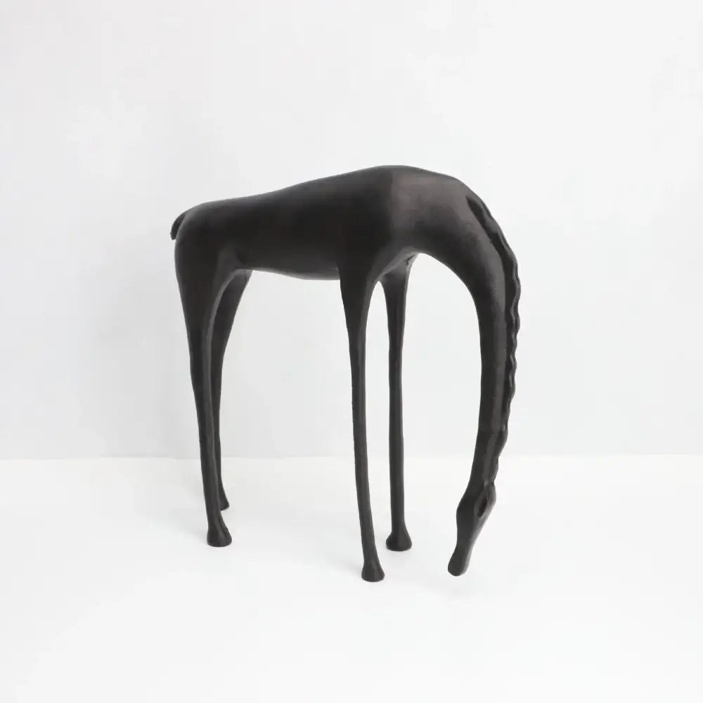 Black matte-finished giraffe-shaped side table with slender legs and minimalist design for decorbites abstract horse iron sculpture decor