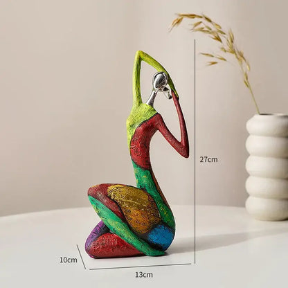 Vibrant multi-colored resin decorbites abstract woman sculpture with intricate patterns and metallic silver headpiece